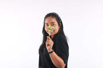 Fashion portrait young woman and lollipop is having fun over white background.