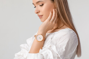 Woman with stylish wrist watch on white background