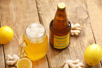 Wall Mural - Bottle and mason jar of fresh ginger beer on wooden background