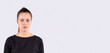 © Viorel - Banner, long format. Young serious woman in a black sweater studio photo portrait isolated on grey background. Thoughtful young businesswoman wit side space for advertisement, info