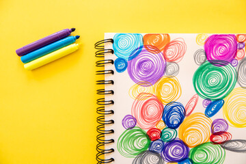 Poster - Top view of purple, yellow, and blue markers with colorful spirals background