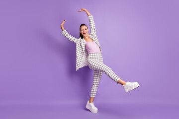 Wall Mural - Full size photo of young attractive cheerful funky smiling businesswoman dancing isolated on violet color background