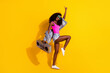 © deagreez - Full length profile side photo of young afro girl happy positive smile hold boombox have fun isolated over yellow color background
