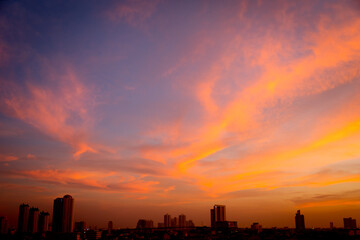 Wall Mural - Sunset sky with city in the shadow