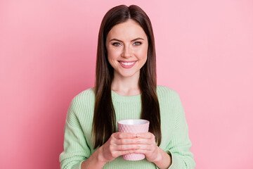 Poster - Photo of optimistic pretty brunette girl hold cup wear lime shirt isolated on pink color background