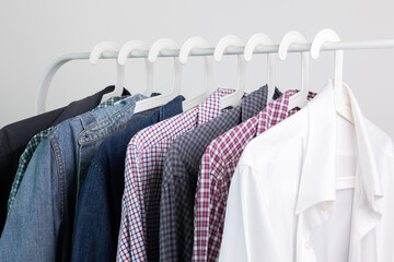 Many shirts hang on the clothesline, many colored shirts.