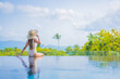 © siraphol - Portrait beautiful young asian woman enjoy around outdoor swimming pool with sea view