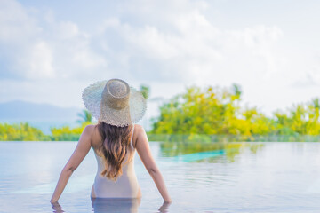 Sticker - Portrait beautiful young asian woman enjoy around outdoor swimming pool with sea view