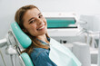 © Drobot Dean - European young woman smiling while sitting in medical chair
