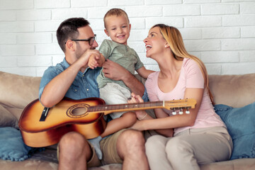 Poster - Happy family play guitar at home