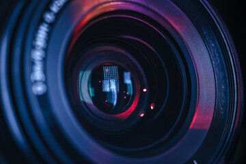 Poster - Close up Beautiful camera lens with multi colored light. Background pattern for design..