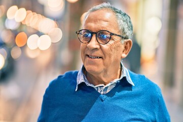 Wall Mural - senior grey-haired man smiling happy standing at the city.