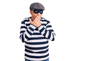 Sticker - Senior handsome man wearing burglar mask and t-shirt laughing and embarrassed giggle covering mouth with hands, gossip and scandal concept