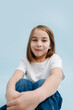 © zzzdim - Sitting 9 year old girl with perky smile and tip of her tongue stuck out