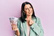 © Krakenimages.com - Middle age brunette woman holding russian 500 ruble banknotes smiling happy pointing with hand and finger