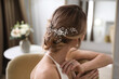 © New Africa - Young bride with elegant wedding hairstyle in room, back view