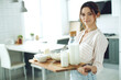 © nuzza11 - Young woman with milk, cottage cheese, sour cream, cheese in the kitchen at home indoors, beautiful girl sitting at the table, happy woman smile, natural organic. High quality photo.