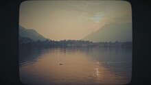 Ducks Swimming In A Lake At Sunset. Vintage Film Look. 