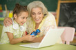 © aletia2011 - portrait of  grandmother and granddaughter playing video game