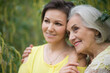 © aletia2011 - Smiling senior woman with adult daughter in autumnal park