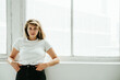 © Alex from the Rock - Pretty blond hair woman posing near bright loft window