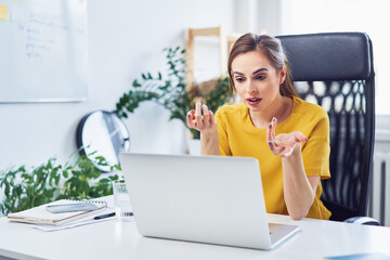 Wall Mural - Young businesswoman discussing on video call in office