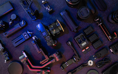 top view of work space photographer with digital camera, gimbal stabilizers and camera accessory