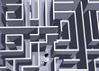 © New Africa - Businessman trying to find way out of maze, above view