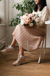 © Natalia - young brunette girl with a bouquet of flowers sits on a chair