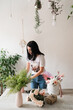 © Natalia - florist girl at work brunette collects a bouquet of flowers on the table