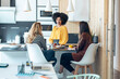 © nenetus - Three smart entrepreneur women talking while taking a break and having a breakfast in the kitchen at coworking place.