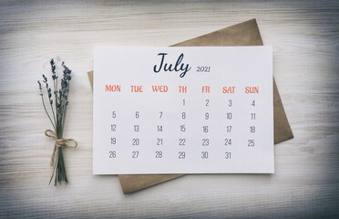 Wall Mural - Calendar page: July 2021. Paper calendar on white paper for the whole month, on top of kraft paper envelope, next to bouquet of dried lavender on wooden white background. The concept of calendar date