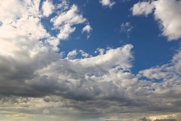 Wall Mural - dramatic blue sky with rays and white clouds