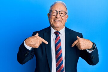 Poster - Senior caucasian man wearing business suit and tie looking confident with smile on face, pointing oneself with fingers proud and happy.