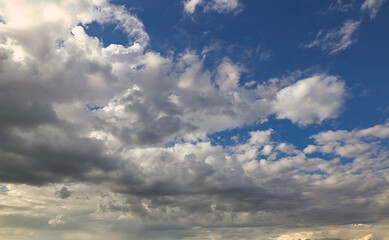 Wall Mural - dramatic blue sky with rays and white clouds