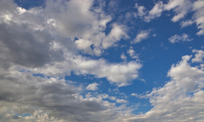 Wall Mural - dramatic blue sky with rays and white clouds