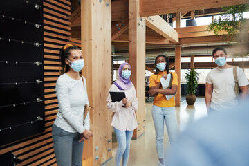 Wall Mural - Diverse businesspeople wearing face masks at work