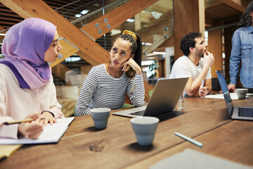 Poster - Young businesswomen talking together during a meeting