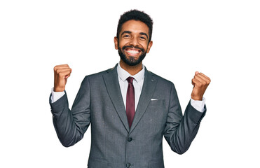 Canvas Print - Young african american man wearing business clothes celebrating surprised and amazed for success with arms raised and open eyes. winner concept.