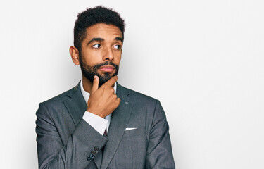 Canvas Print - Young african american man wearing business clothes with hand on chin thinking about question, pensive expression. smiling with thoughtful face. doubt concept.