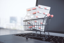 Pharma Business Online Concept With Pills In Shopping Cart On Modern Laptop Keyboard
