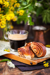 Wall Mural - Homemade cinnamon and cardamom rolls (buns) and cup of black coffee