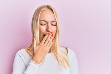 Wall Mural - Young blonde girl wearing casual clothes bored yawning tired covering mouth with hand. restless and sleepiness.