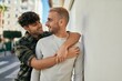 © Krakenimages.com - Young gay couple smiling happy and hugging at the city.