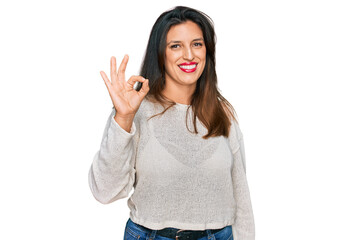 Sticker - Beautiful hispanic woman wearing casual sweater smiling positive doing ok sign with hand and fingers. successful expression.