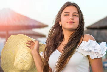 Wall Mural - Portrait of teenage cheerful plus size teenage girl wearing hat enjoying the beach. smiling, happy, positive emotion, summer style.