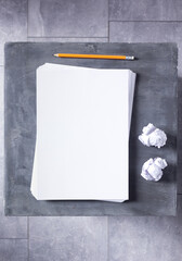 Poster - Stack of paper sheet with empty pages on table background. Creative idea concept