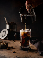 Cold coffee with cream on a dark background