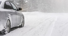 Silver Car Parked On Snow Covered Road, Detail View From Behind, Blurred Trees Background Empty Space For Text Right Side