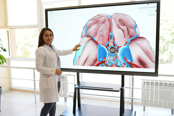 scientist or medical student working with computer in laboratory with human organs on it